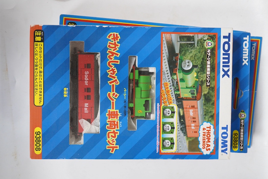 Four boxed Tomix (by Tomy) N gauge railway Thomas the Tank Engine & Friends train packs, comprising of three locomotives and rolling stock (one locomotive missing): James (93802), Henry (93805), Percy (93808) and Thomas